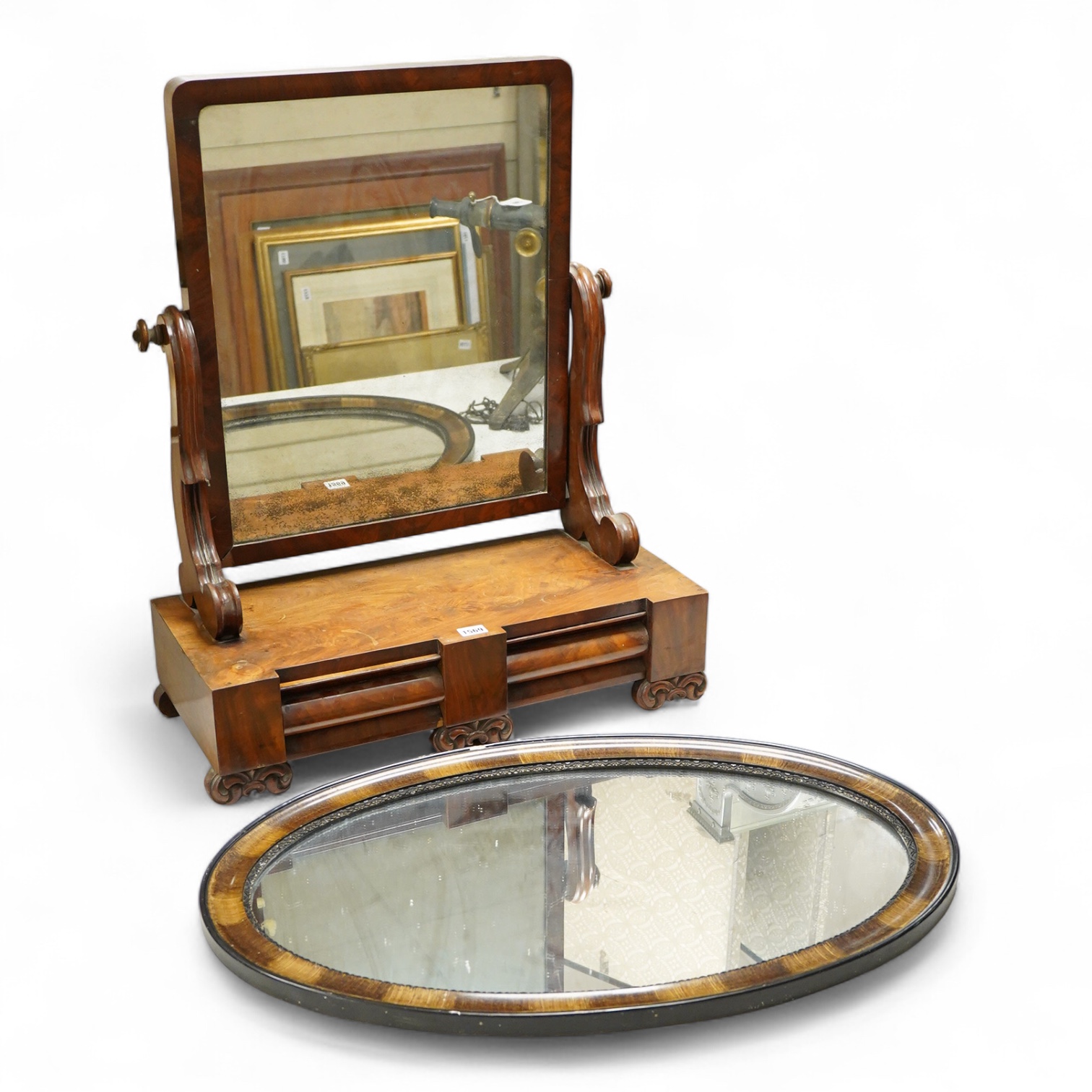 A mahogany toilet mirror and an oval wall mirror, 77cm wide